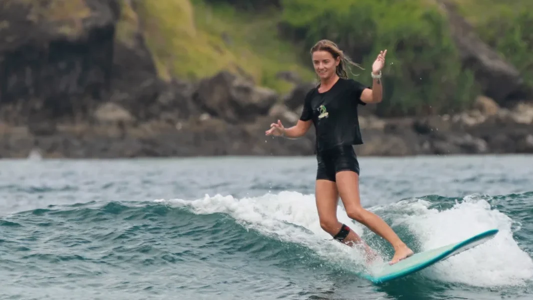 SurfWell Student trying to ride small waves
