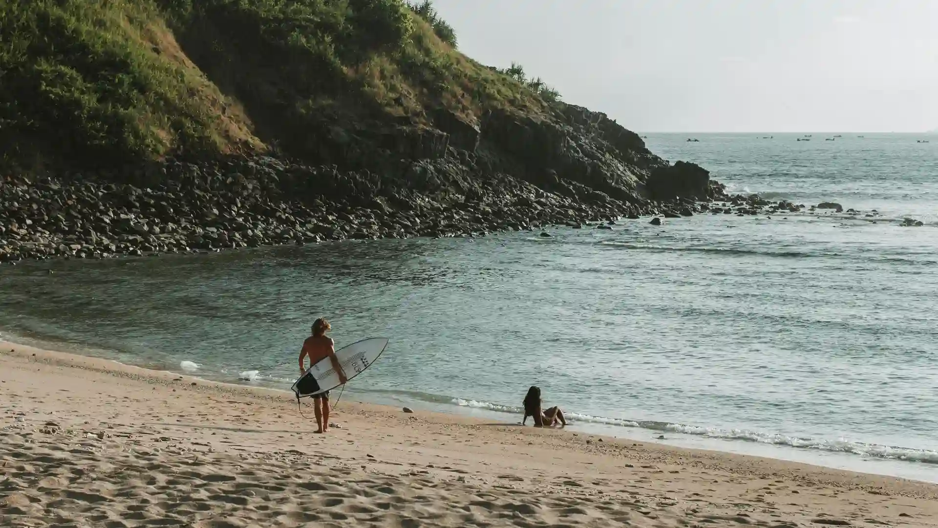 Surfers riding waves at Gerupuk Bay in Kuta Lombok