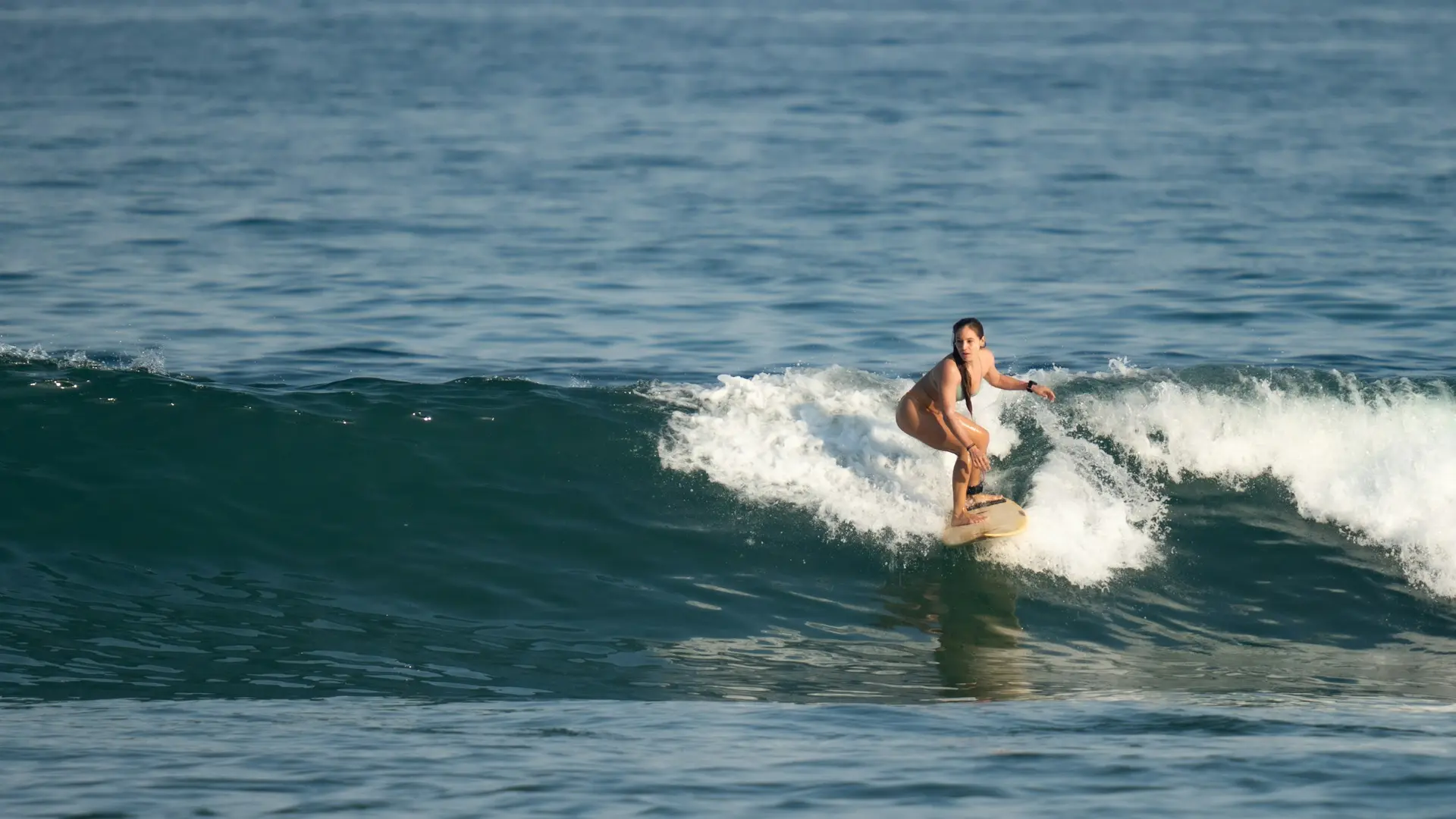 Surfing Senggigi Lombok at sunrise with calm waves