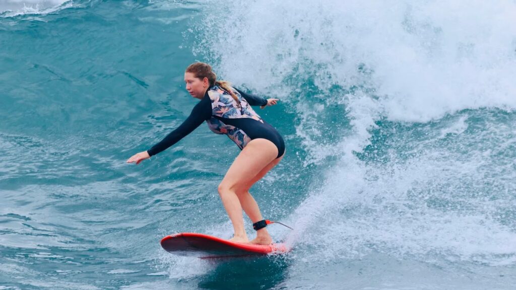 SurfWell guest riding a wave during a Bali surf trip experience