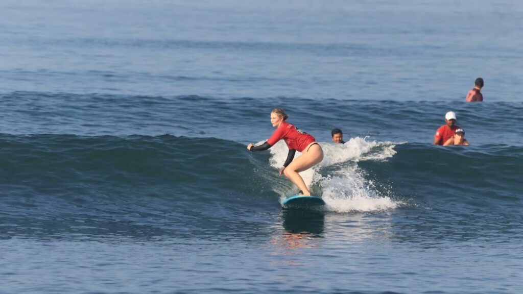 SurfWell student riding a beginner friendly wave at Batu Bolong Beach Canggu Bali