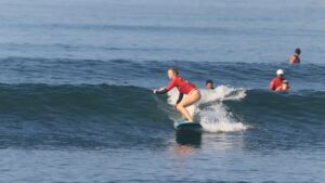 SurfWell student riding a beginner friendly wave at Batu Bolong Beach Canggu Bali