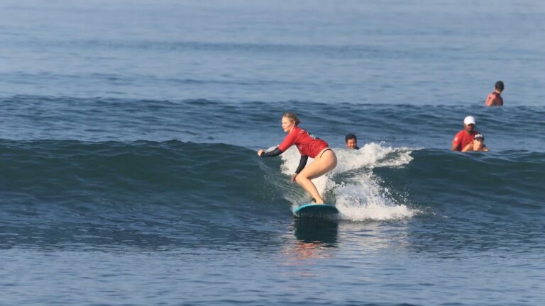 SurfWell student riding a beginner friendly wave at Batu Bolong Beach Canggu Bali