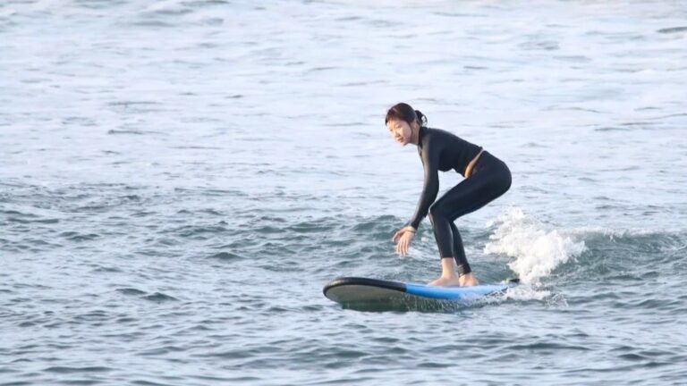 Surfer riding a fast reef wave at Serangan surf spot in Bali